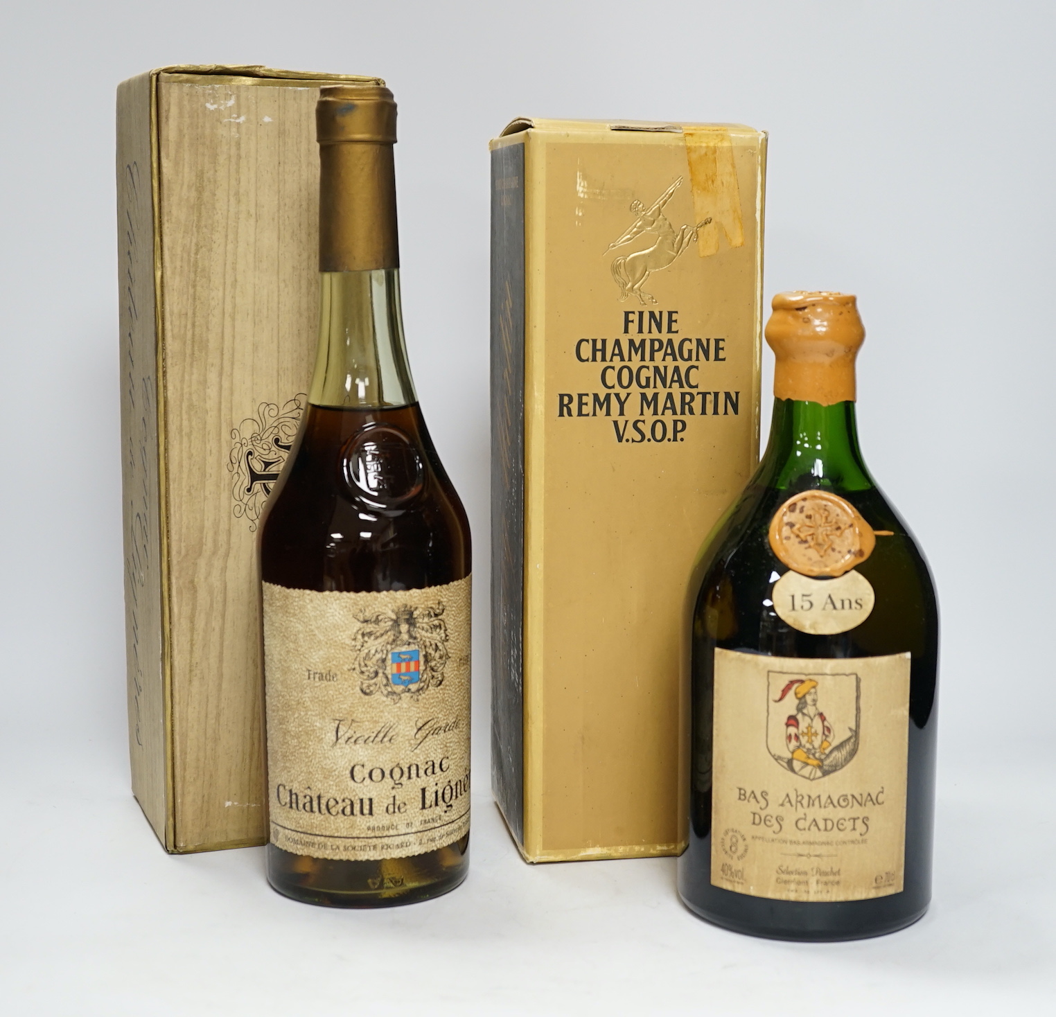 A boxed bottle of Remy Martin VSOP Cognac, a boxed bottle of Cognac Chateau de Lignres and a bottle of Bas Armagnac Des Cadets